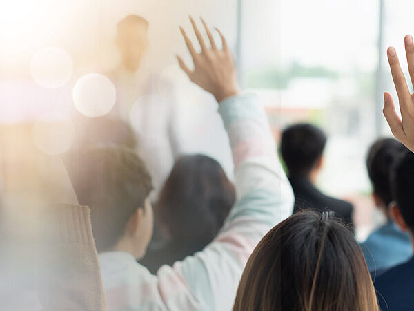 Veranstalungs mit Teilnehmern, die Fragen stellen